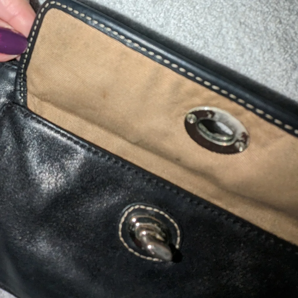 Coach black leather turn lock flap wristlet.